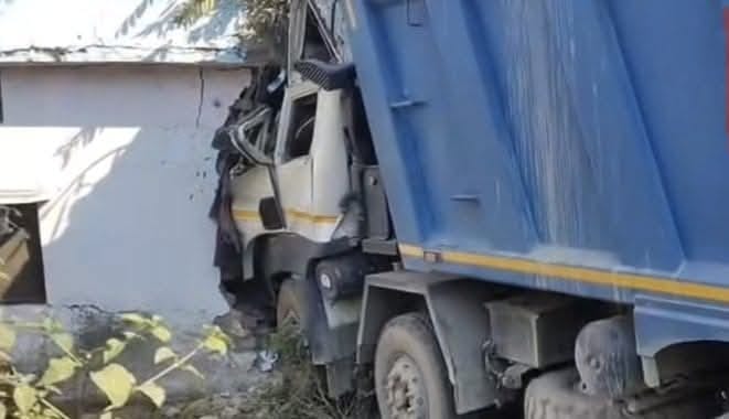 A dumper broke into a house wall, injuring a woman.