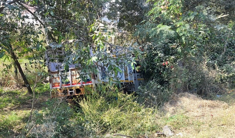 A speeding car hit a pickup parked on the highway, injuring the driver.