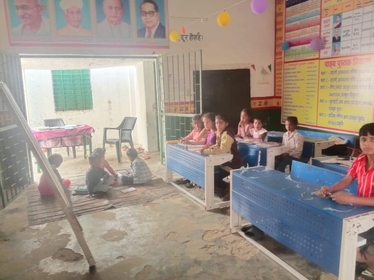 Due to lack of teachers, many classes are running in the same classroom.