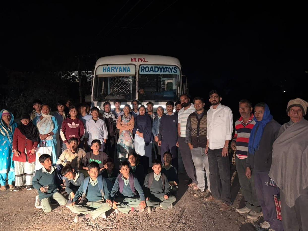 The bus was stopped before the students could reach their destination; the students expressed their anger by sitting in front of the bus.
