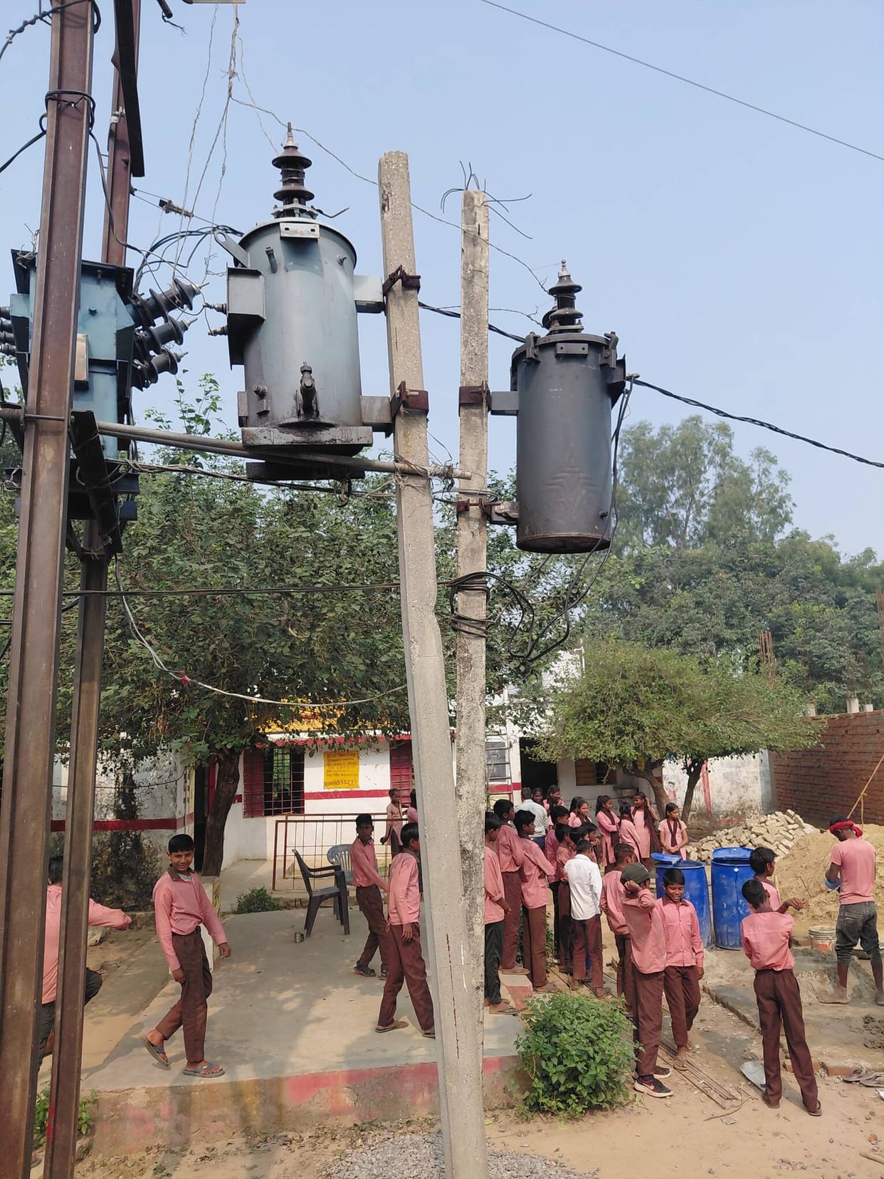 Wires pass over the school, compromising safety.