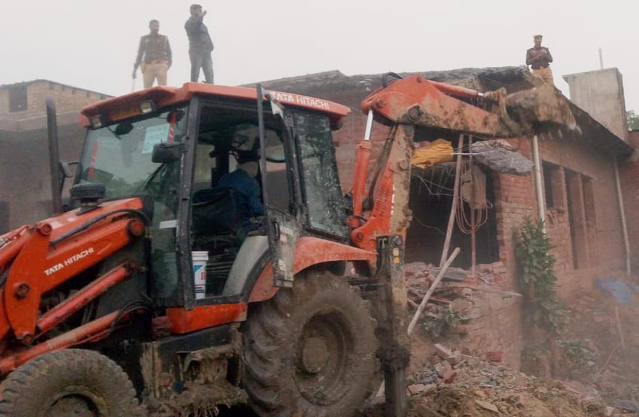 The Forest Department demolished part of a house built on government land using a JCB.
