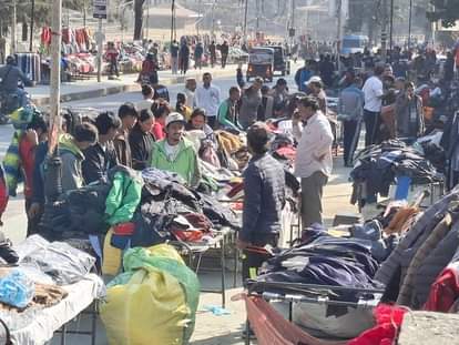 People gather to shop at the Sunday market
