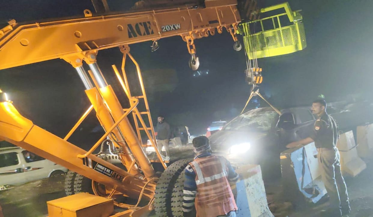 A speeding car collided with a highway divider and overturned, injuring two.