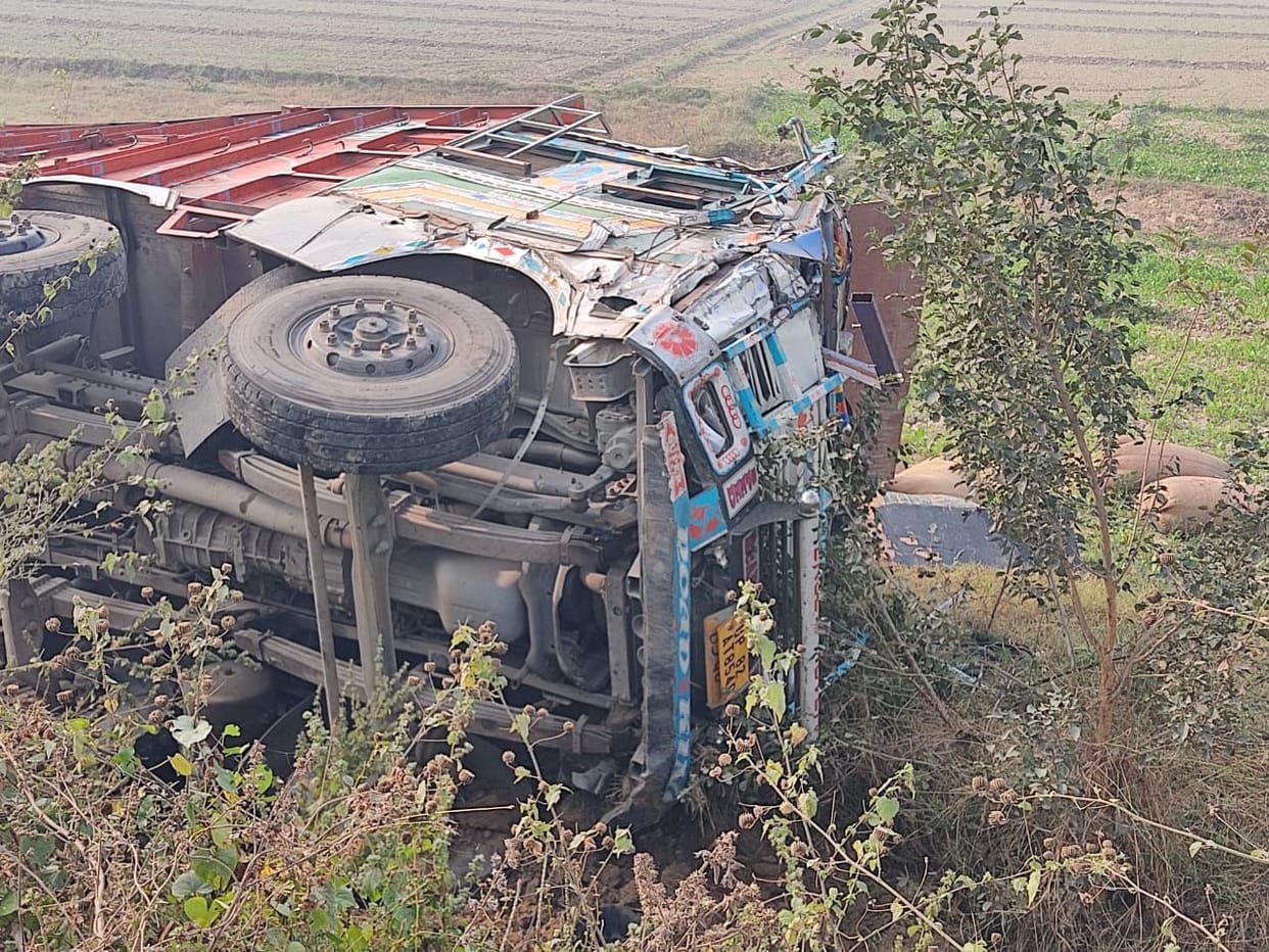 Truck overturns in ditch after collision with pickup, driver injured