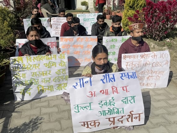 The student council staged a silent protest by tying black bands on their mouths.