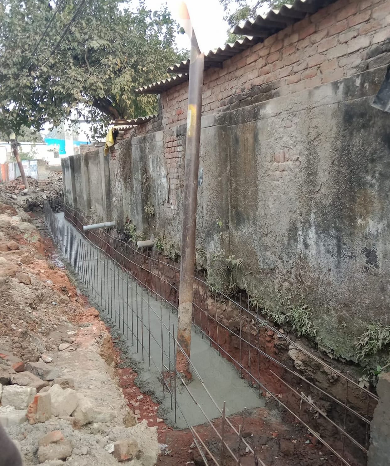 An electric pole stands in the middle of a drain in Shivapuram, and electricity can spread at any time.