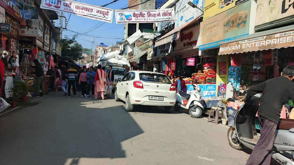 Due to the lack of footpaths in the city, pedestrians are on the roads and shops are set up on the drainage drains.