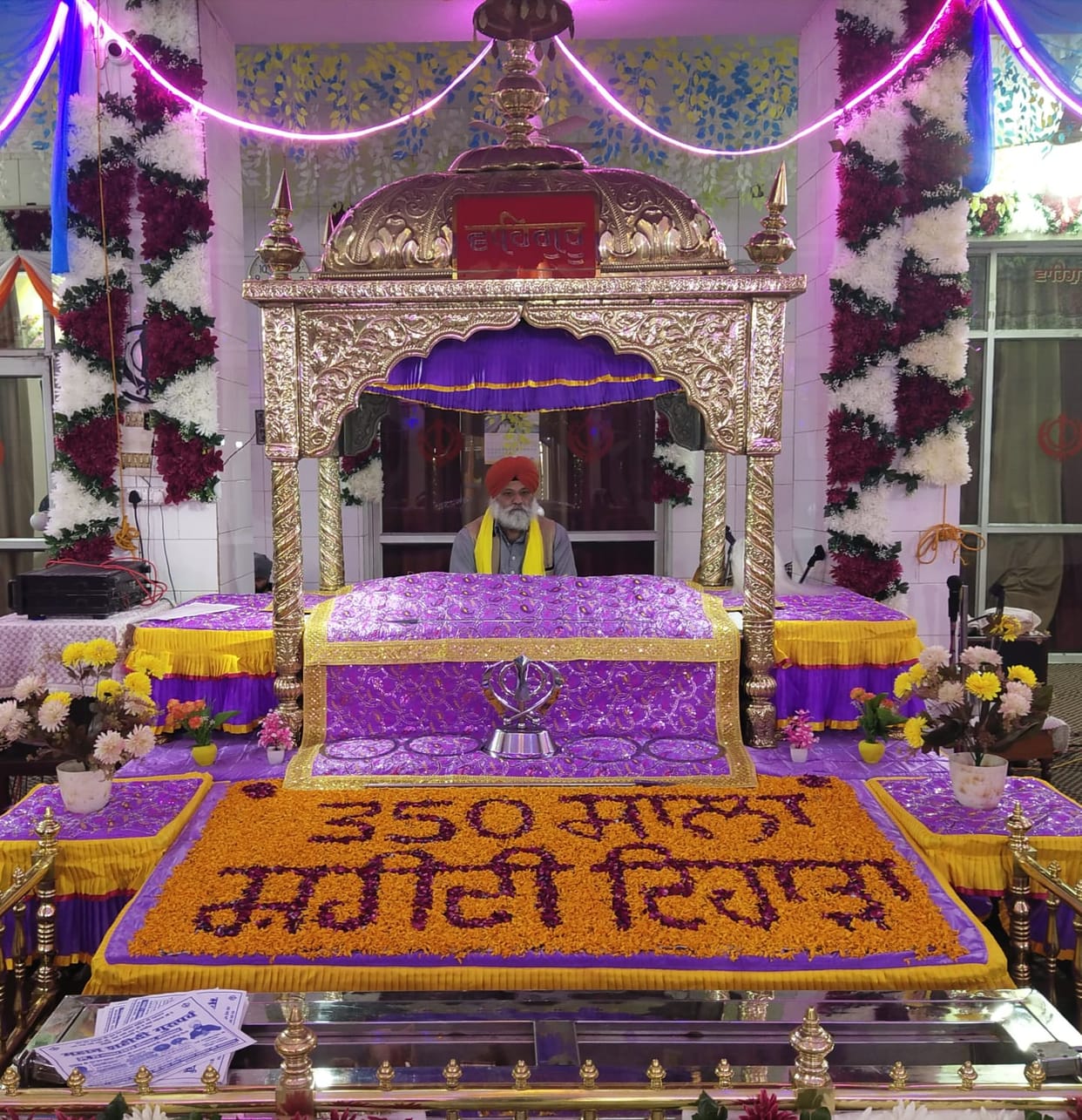 The congregation bowed their heads before the Diwan in the Gurdwara.