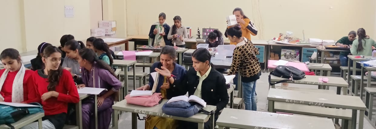 In the absence of a lab at the women's college, students are experimenting with chemical reactions using borrowed test tubes.