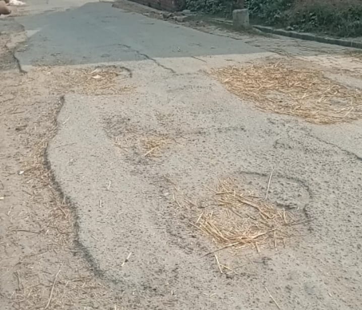 Potholes dot the entire one kilometer stretch of road, causing traffic problems