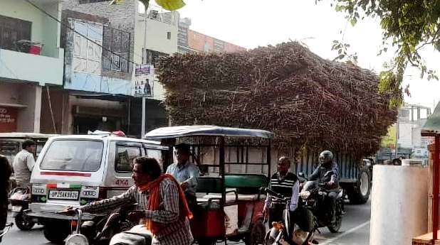 Overloaded trucks and tractor-trolleys loaded with sugarcane are violating traffic rules.