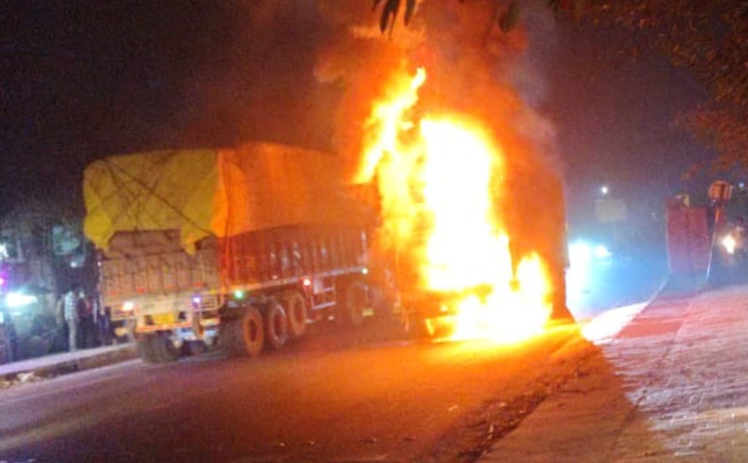 A truck loaded with chemicals caught fire after colliding with a bike, blocking the Hasanpur-Gajraul road.