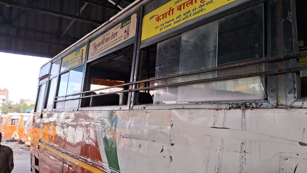 Passengers travel in buses with broken windows and shivering cold.