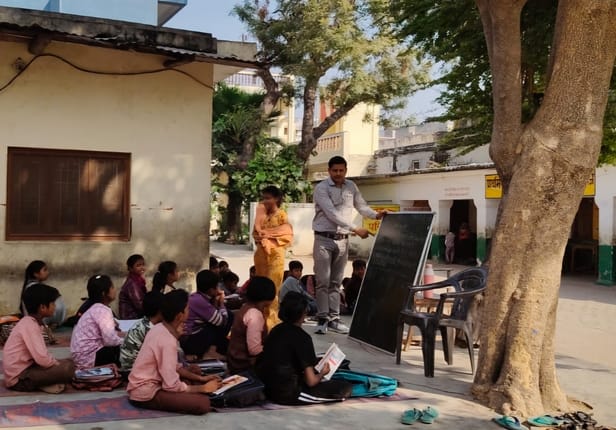 The school building was incomplete, with classrooms under trees.