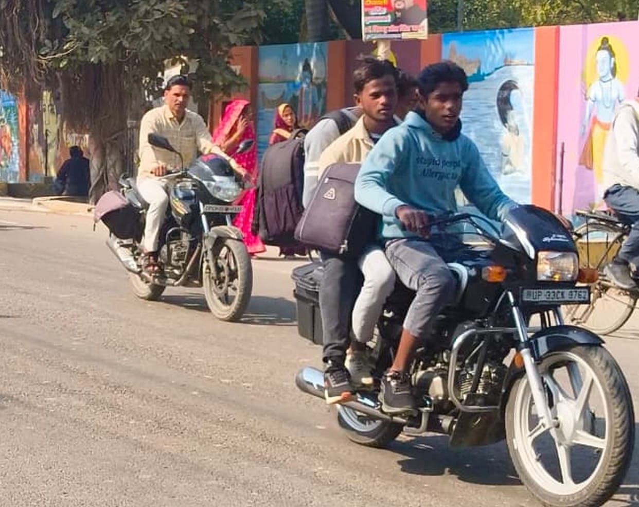 Young man riding a bike while talking on his mobile phone
