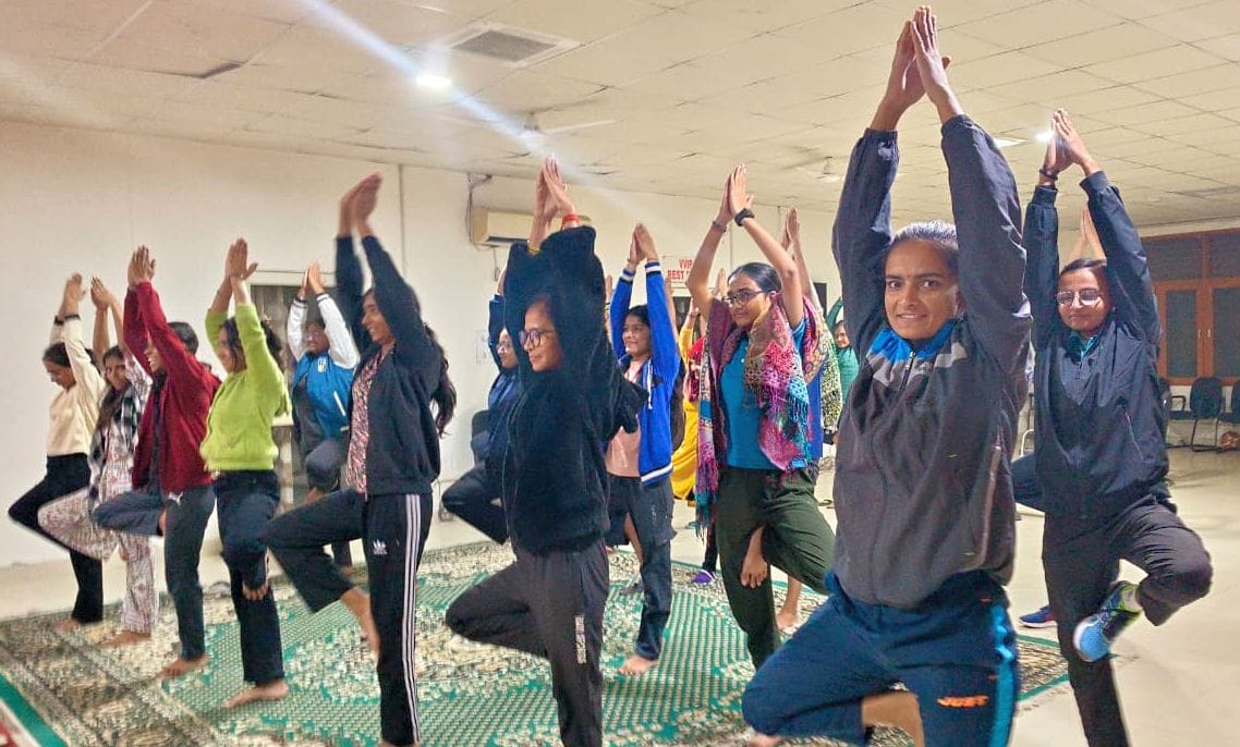 Explain the benefits of yoga to the girl students in the university