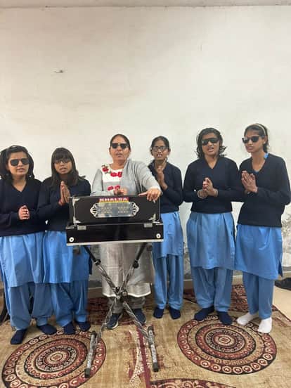 Overcoming disability, she teaches music to children