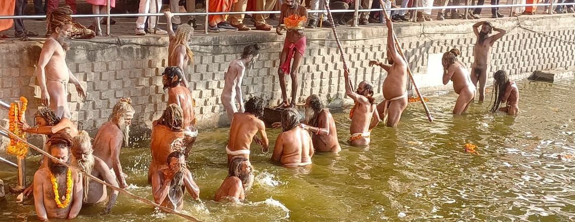 Naga sadhus take a dip in the Ganga at the conclusion of the royal procession.