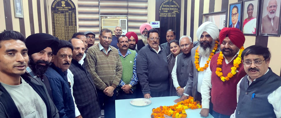 Workers welcome newly appointed office bearers with garlands