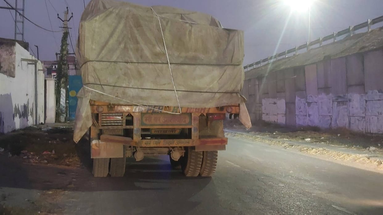 Heavy vehicles parked halfway down the road without reflectors and lights.