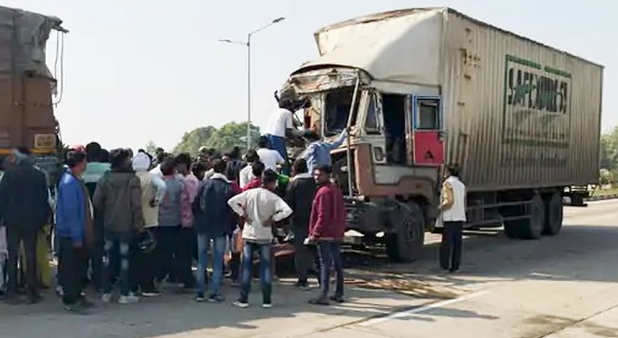 Container rams into parked truck, four people including driver trapped