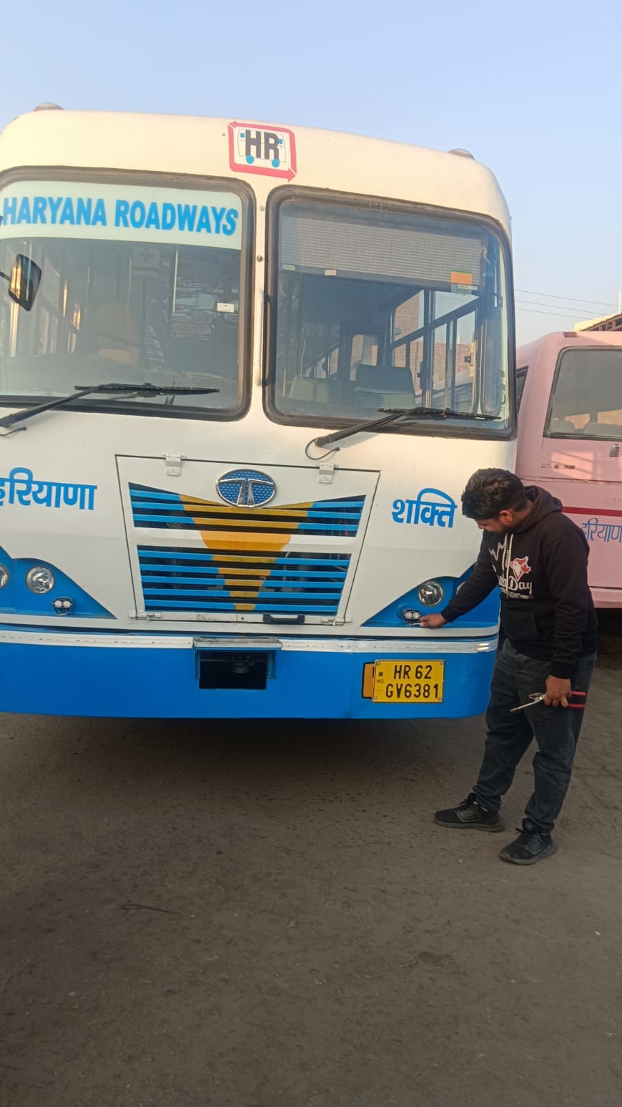 Work of installing fog lights in roadways buses before the fog arrives