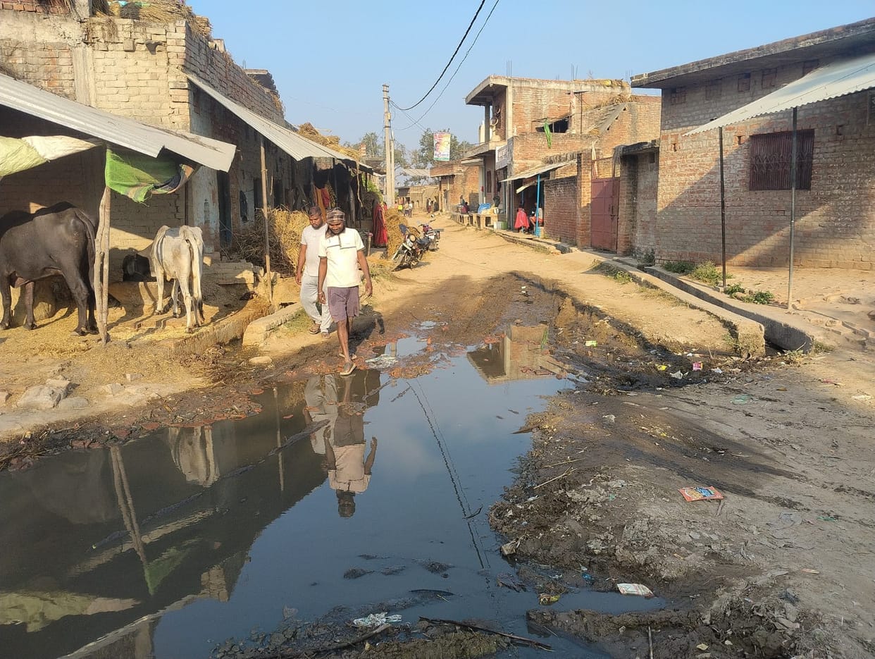 Waterlogging on the main road causes problems for villagers