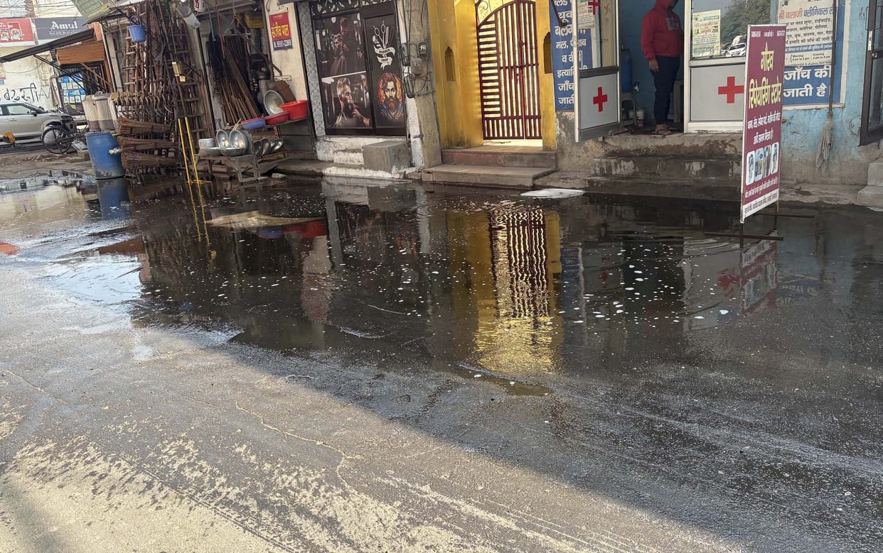 Dirty sewer water accumulated on the road, people troubled