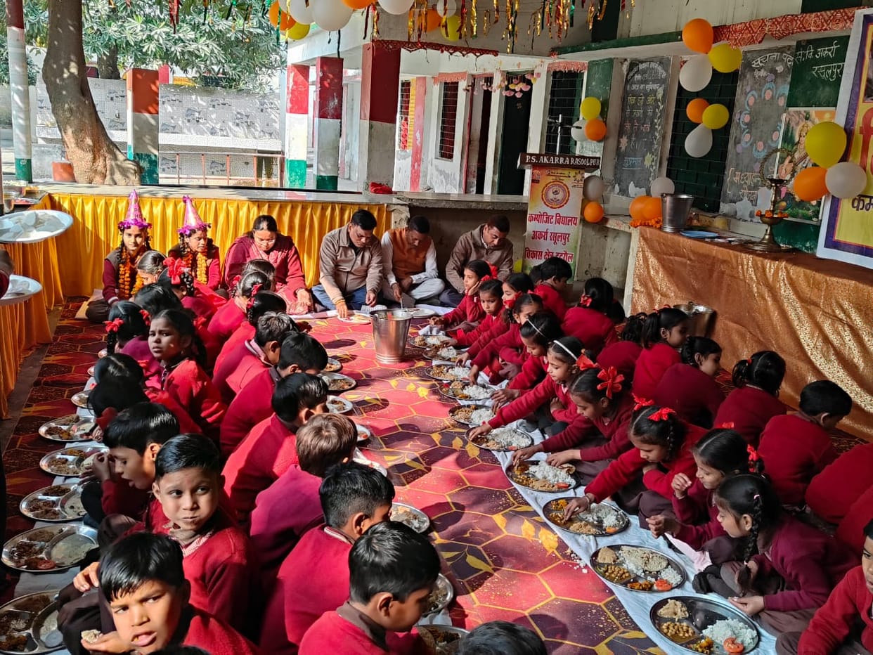 The children enjoyed their meal while sitting with the guests.