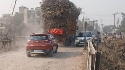Farmers transporting sugarcane through bumpy roads, overloaded vehicles risk overturning