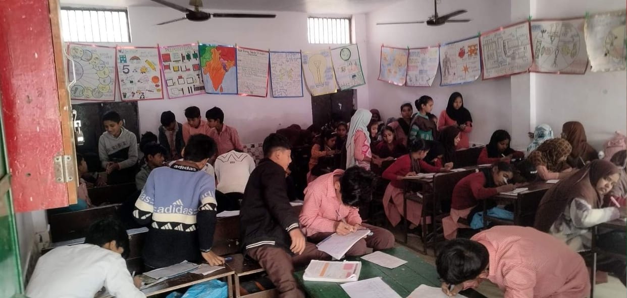 Teachers are busy with their work and children are busy copying.