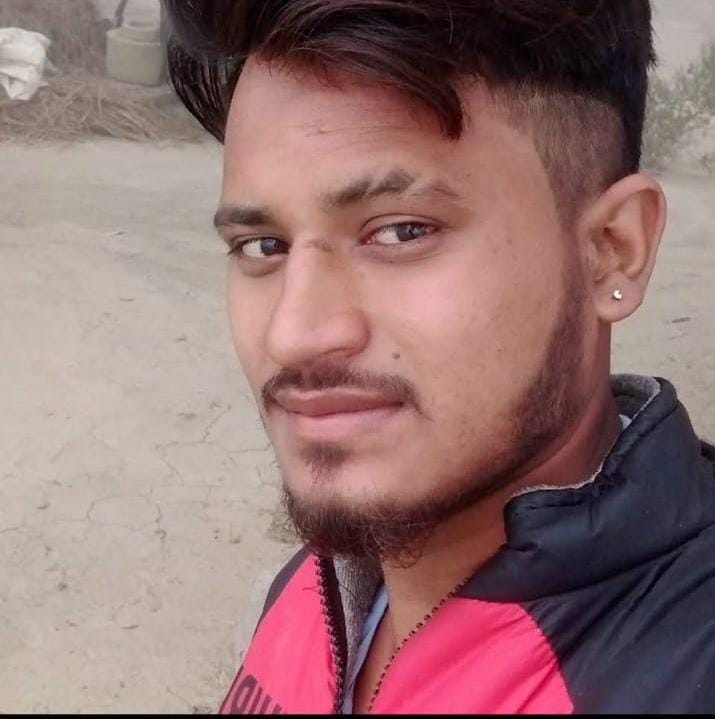 The young man's body was found hanging from a tree; the forensic team collected evidence.