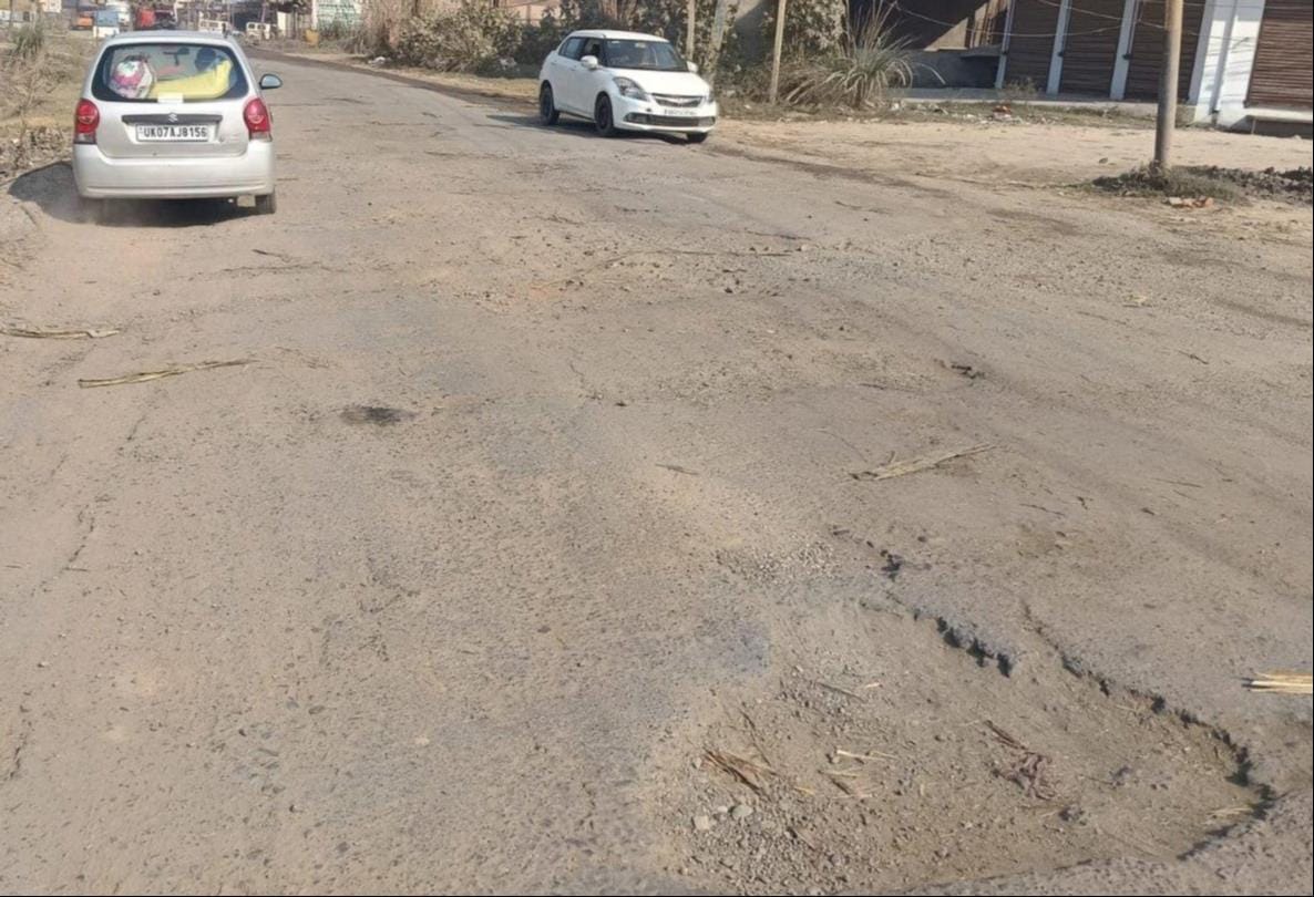 The bypass road is full of potholes, causing jolts for pedestrians.