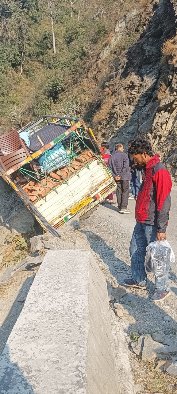 Pickup stuck on parapet, woman injured