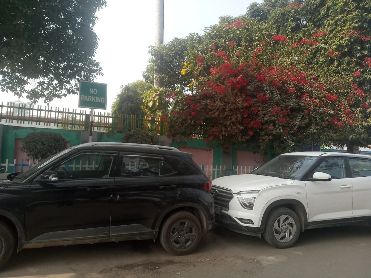 Vehicles parked recklessly in no-parking zones at the railway station, causing inconvenience to passengers.