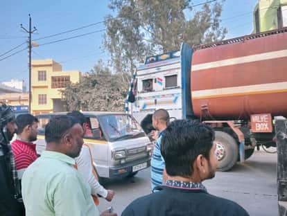 A van hit the motorcyclist, who narrowly escaped being hit by a trailer truck.