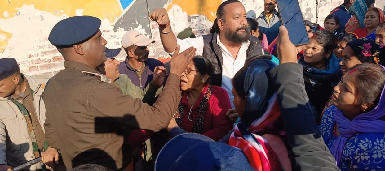 People forcibly entered the ground to protest against the construction and sat on a dharna in front of the JCB.