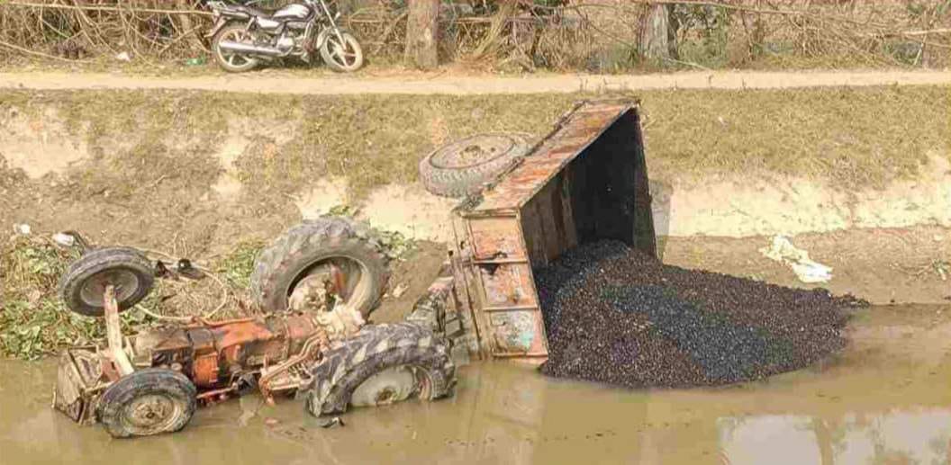 Uncontrolled tractor overturned into canal while backing, driver died