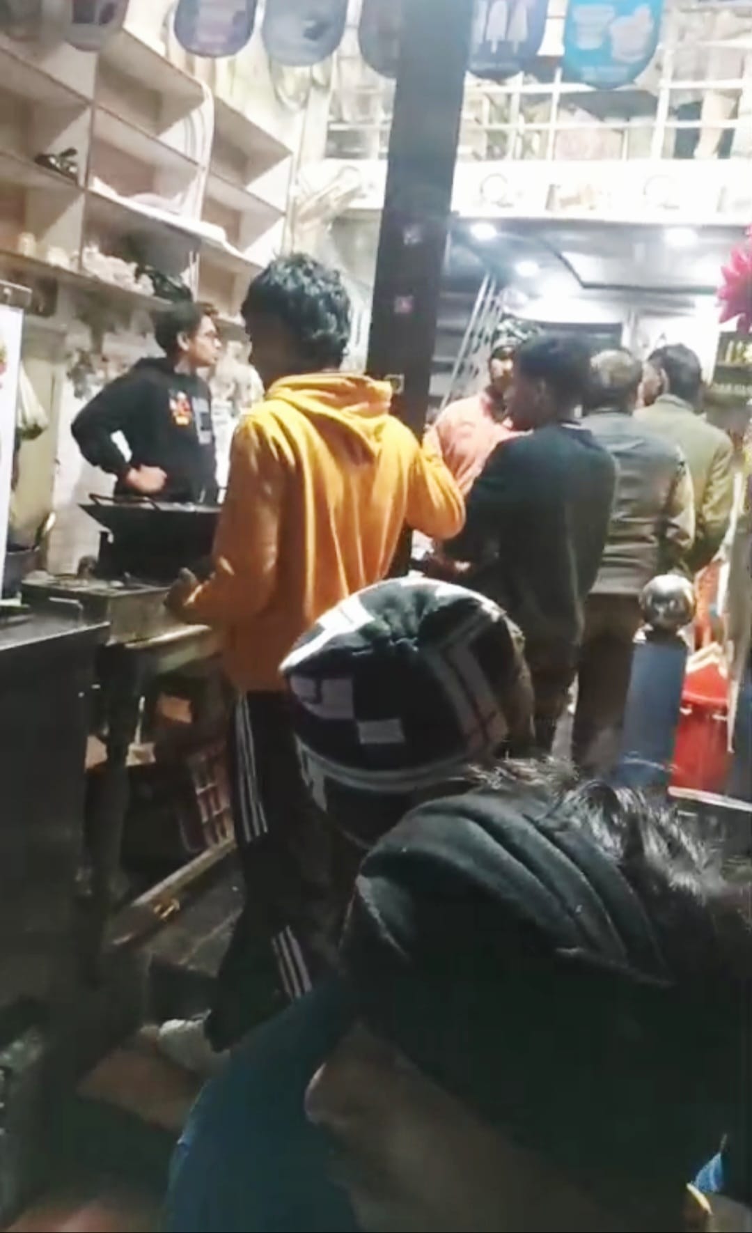 A young man eating chowmein at a shop was shot in the hand.