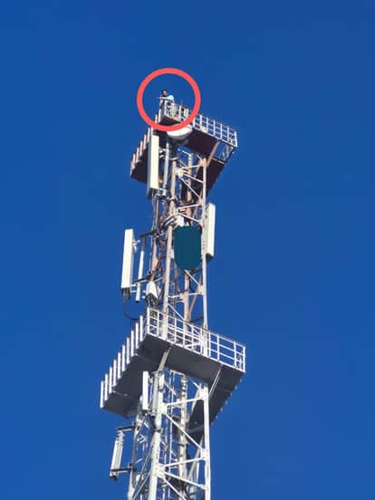 A farmer climbed a tower to seek justice after his land was seized. Police brought him down