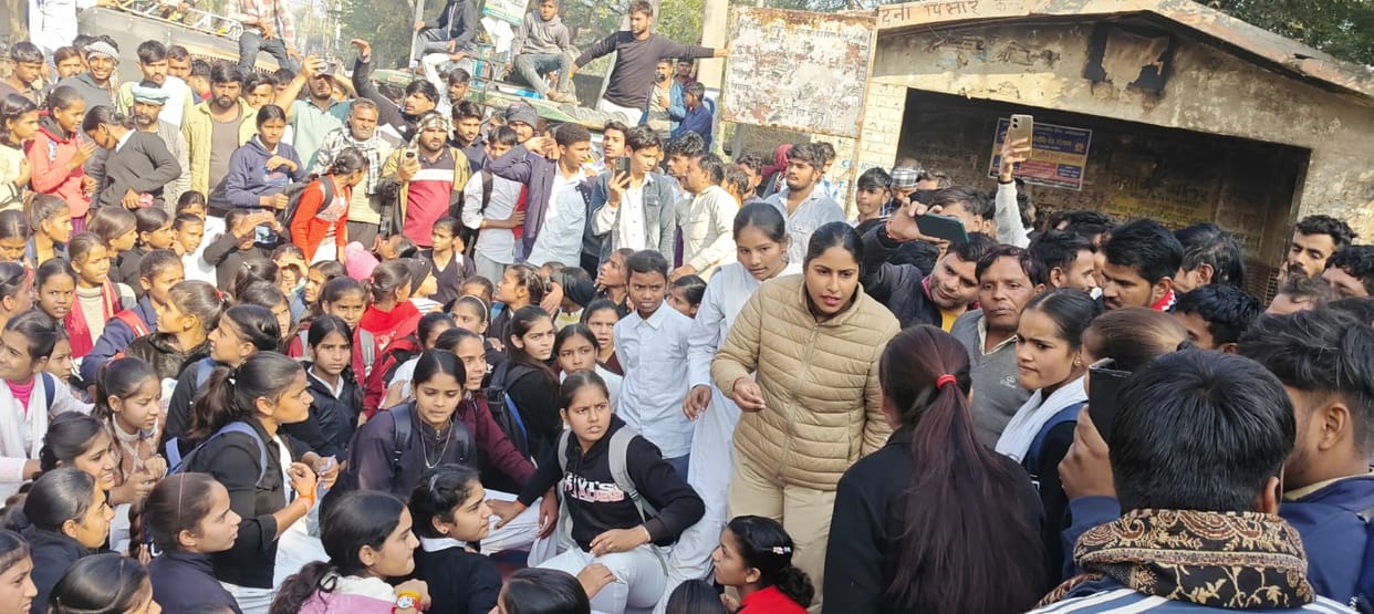 Students blocked the road over the principal's suspension.