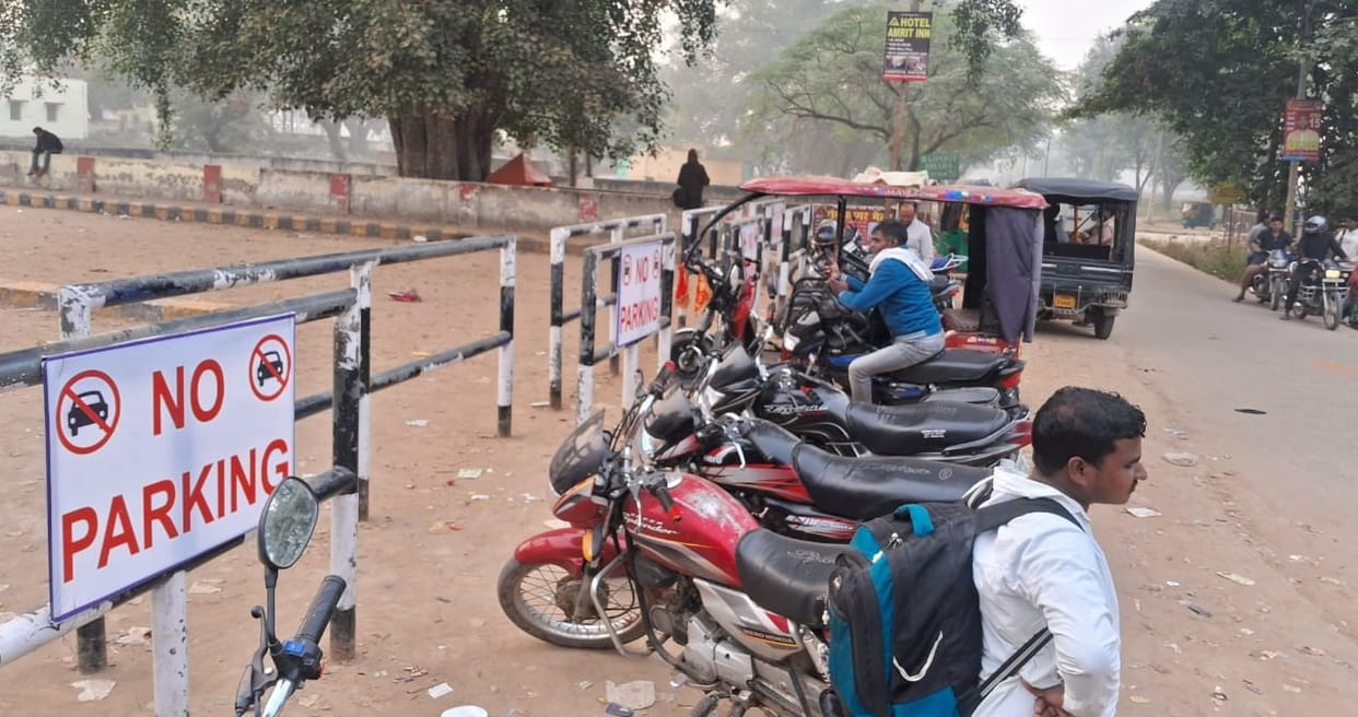 Vehicles parked near no parking sign