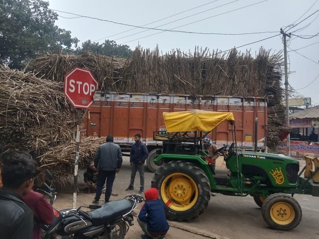 Overloaded sugarcane filled truck collides, causing traffic jam
