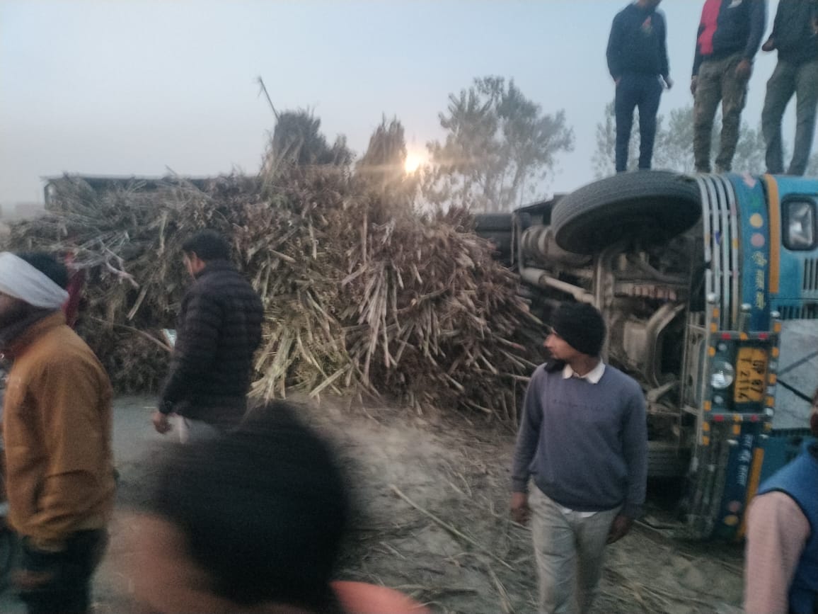 Overloaded truck carrying sugarcane overturned on a bus, injuring nine passengers