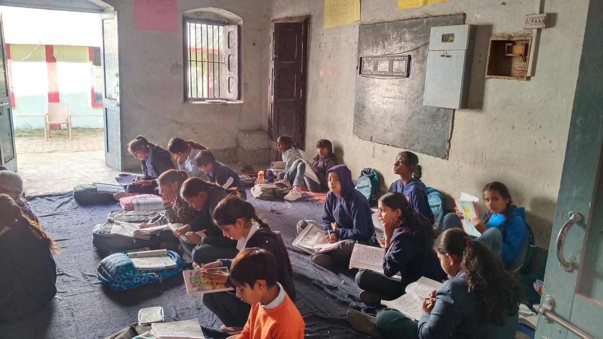 Lack of facilities at PM Shri schools; students forced to sit on mats to study.