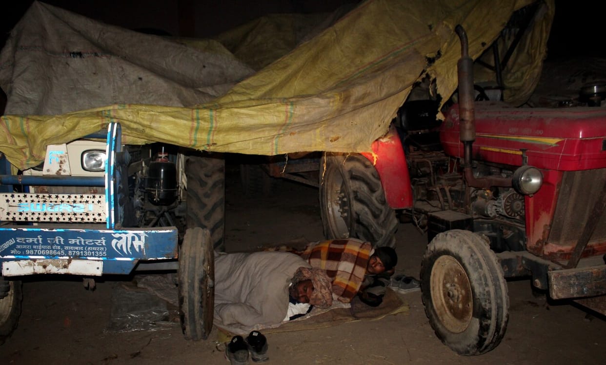 First, they stayed up all night in the fields, and now they are spending cold nights in the market to save their crops.
