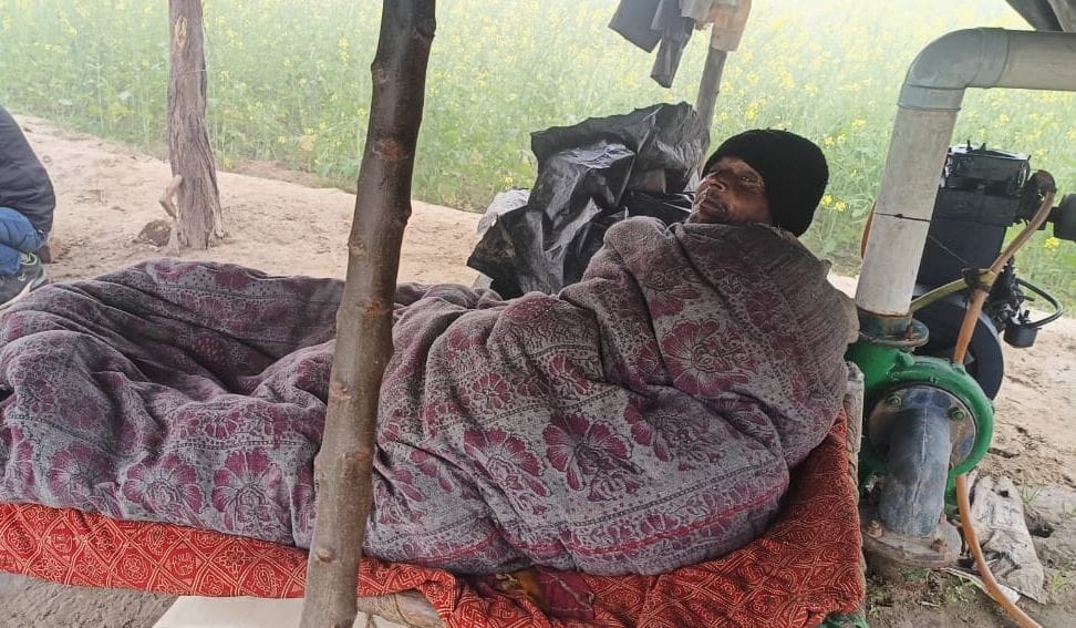 Amidst the cold and fog, farmers are standing guard to protect their crops.