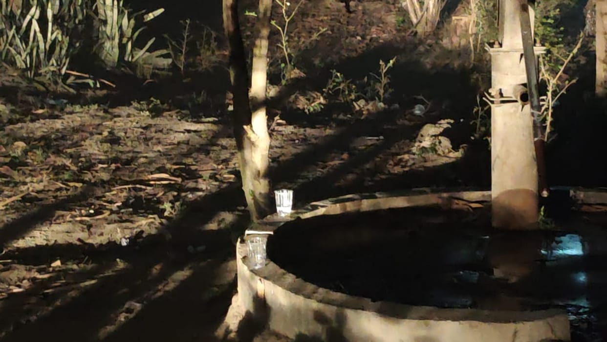 A body was found in a burnt-out hut in a field; police are working to identify the deceased.