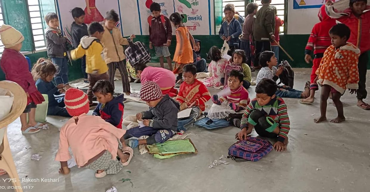 Two Anganwadi centres are operating in the same room, forcing children to sit on the ground in the cold.